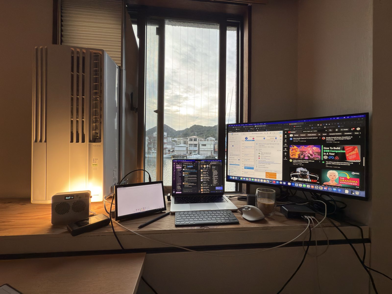 An after-hours workstation with screens still glowing